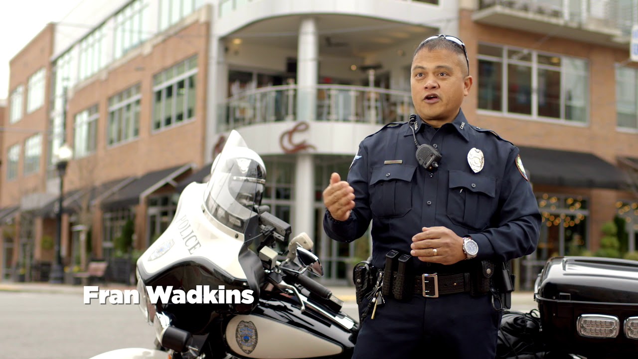 Officer Fran Wadkins in front of motorcycle